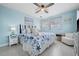 Primary bedroom with a king bed, beach decor, and white nightstands at 2726 N Beach Rd, Englewood, FL 34223