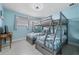 Guest bedroom with a bunk bed and coastal bedding at 2726 N Beach Rd, Englewood, FL 34223