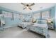 Guest bedroom with twin beds, light blue walls, and beach decor at 2726 N Beach Rd, Englewood, FL 34223