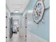 Light hallway with white wainscoting and a nautical-themed clock at 2726 N Beach Rd, Englewood, FL 34223