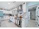 Modern kitchen with white cabinets, stainless steel appliances, and marble countertops at 2726 N Beach Rd, Englewood, FL 34223