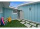 Private outdoor shower with blue siding and stone tile at 2726 N Beach Rd, Englewood, FL 34223