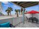 Outdoor patio with seating area, table, and beach views at 2726 N Beach Rd, Englewood, FL 34223