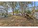 Landscaped backyard with mature trees and gate at 3189 Tally Ho Rd, North Port, FL 34291