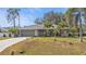 Single-story home with attached garage and landscaped lawn at 3189 Tally Ho Rd, North Port, FL 34291