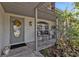 Covered porch with seating and potted plants at 3189 Tally Ho Rd, North Port, FL 34291