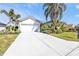 House exterior featuring a two-car garage and manicured lawn at 3380 Bay Ridge Way, Port Charlotte, FL 33953