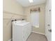 Laundry room with washer, dryer, and shelving at 3380 Bay Ridge Way, Port Charlotte, FL 33953