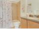 Small bathroom with tub shower combo and flamingo-themed decor at 3533 Lakewood Blvd, North Port, FL 34287