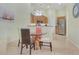 Bright dining area with glass-top table and four chairs at 3533 Lakewood Blvd, North Port, FL 34287