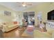 Living room with view of patio and pool area at 3533 Lakewood Blvd, North Port, FL 34287