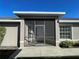 Screened-in porch entry with white door and windows at 3533 Lakewood Blvd, North Port, FL 34287