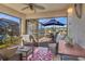 Sunroom with wicker furniture and view of the backyard pool at 3533 Lakewood Blvd, North Port, FL 34287