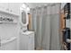 Small bathroom with white vanity and gray shower curtain at 407 Dunn Ne Dr, Port Charlotte, FL 33952