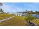 Private boat lift with covered dock and lush landscaping at 407 Dunn Ne Dr, Port Charlotte, FL 33952