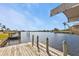 Wooden dock offering scenic waterway views at 407 Dunn Ne Dr, Port Charlotte, FL 33952