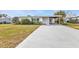 Ranch home with carport and well-maintained lawn at 407 Dunn Ne Dr, Port Charlotte, FL 33952