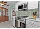 Kitchen with stainless steel appliances and white cabinets at 407 Dunn Ne Dr, Port Charlotte, FL 33952