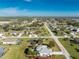 Aerial view showcasing a single-story house with pool in a residential area at 42 Santarem Cir, Punta Gorda, FL 33983