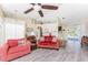 Living room with red couches and hardwood floors at 42 Santarem Cir, Punta Gorda, FL 33983