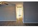 Hallway with gray walls and hardwood floors leading to bedrooms at 4200 Kilpatrick St, Port Charlotte, FL 33948