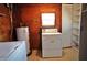 Laundry room with washer, dryer, and storage shelves at 4200 Kilpatrick St, Port Charlotte, FL 33948