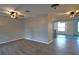 Open living space with hardwood floors and multiple ceiling fans at 4200 Kilpatrick St, Port Charlotte, FL 33948