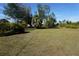 Large backyard with mature trees and grassy area at 422 Omen St, Punta Gorda, FL 33982