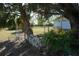 Backyard view with palm tree, lush greenery and white fence at 422 Omen St, Punta Gorda, FL 33982