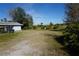 Open backyard with grassy area and trees at 422 Omen St, Punta Gorda, FL 33982