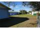 Large backyard with light blue building and grassy area at 422 Omen St, Punta Gorda, FL 33982