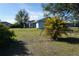 Backyard view showcasing a light blue building and palm trees at 422 Omen St, Punta Gorda, FL 33982