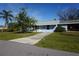 Light blue house with a driveway and green lawn at 422 Omen St, Punta Gorda, FL 33982