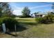 Spacious front yard with a light blue house and lush green grass at 422 Omen St, Punta Gorda, FL 33982