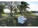 White park bench overlooking a grassy area with trees and a covered picnic table at 422 Omen St, Punta Gorda, FL 33982