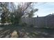 Side yard with wooden fence, greenery, and a tree at 422 Omen St, Punta Gorda, FL 33982