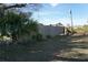 Side yard with wooden fence and lush tropical plants at 422 Omen St, Punta Gorda, FL 33982