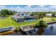 Aerial view showing home, pool, dock, and lush landscaping at 4630 Fallon Cir, Port Charlotte, FL 33948