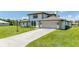 Two-story house with a beige exterior, two-car garage, and spacious driveway at 4630 Fallon Cir, Port Charlotte, FL 33948