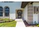 Front entrance with a black wrought iron door and a walkway at 4630 Fallon Cir, Port Charlotte, FL 33948