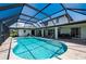 Enclosed kidney-shaped pool with canal view at 4630 Fallon Cir, Port Charlotte, FL 33948