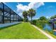 Landscaped lawn leading to canal and dock at 4630 Fallon Cir, Port Charlotte, FL 33948