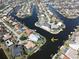 Aerial view of house on a canal with lush landscaping at 490 Sorrento Ct, Punta Gorda, FL 33950