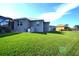 House backyard with grassy lawn and partial view of neighboring house at 490 Sorrento Ct, Punta Gorda, FL 33950