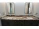 Bathroom with double vanity, granite countertop, and large mirrors at 490 Sorrento Ct, Punta Gorda, FL 33950