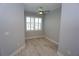 Spacious bedroom with wood-look tile floors and window with shutters at 490 Sorrento Ct, Punta Gorda, FL 33950