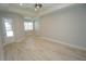 Bright bedroom with wood-look tile flooring, and door leading outside at 490 Sorrento Ct, Punta Gorda, FL 33950