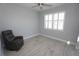 Bedroom with large window, ceiling fan, and recliner chair at 490 Sorrento Ct, Punta Gorda, FL 33950