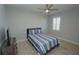 Bedroom with striped bedding, ceiling fan, and TV at 490 Sorrento Ct, Punta Gorda, FL 33950