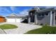 Modern home with gray siding, metal roof, and paver driveway at 490 Sorrento Ct, Punta Gorda, FL 33950